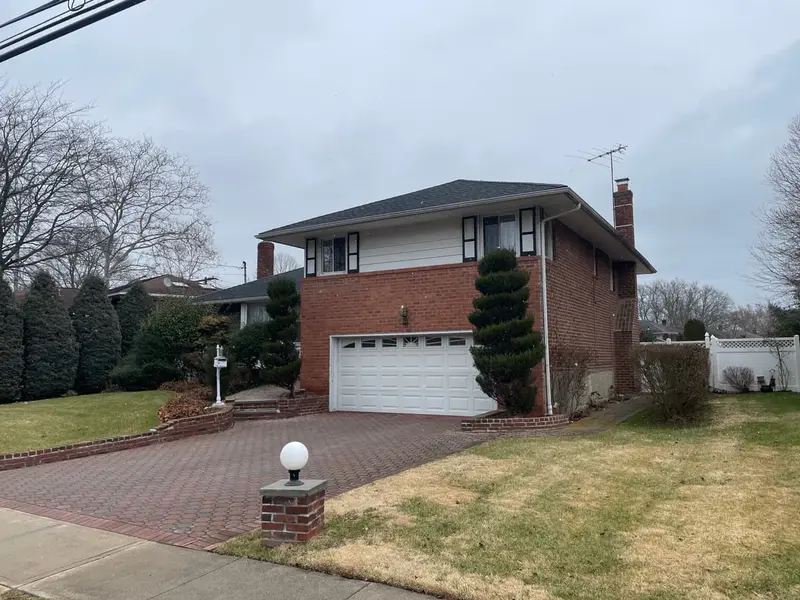 Brick high ranch with a two car garage, Westbury, NY