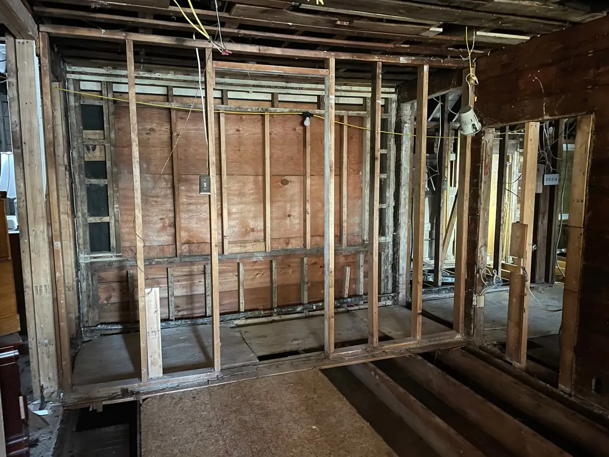 Selling a house with unpermitted work in Westbury: interior gutted down to the studs and subfloor