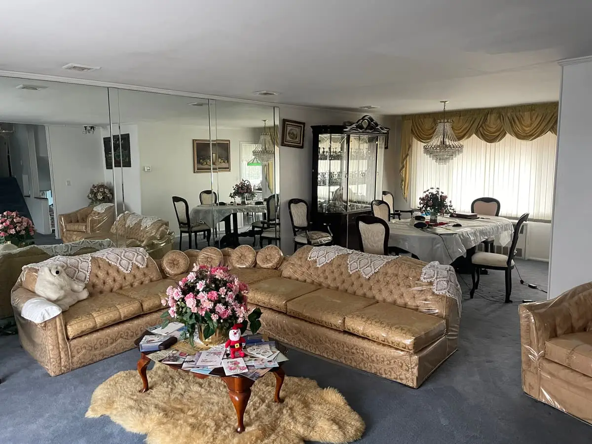 Selling estate property as an executor in Westbury: living room with plastic covered sofas and mirrored walls
