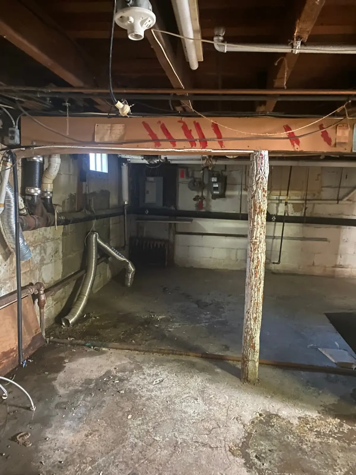 Wondering what your Westbury house is worth: unfinished basement with a log support post